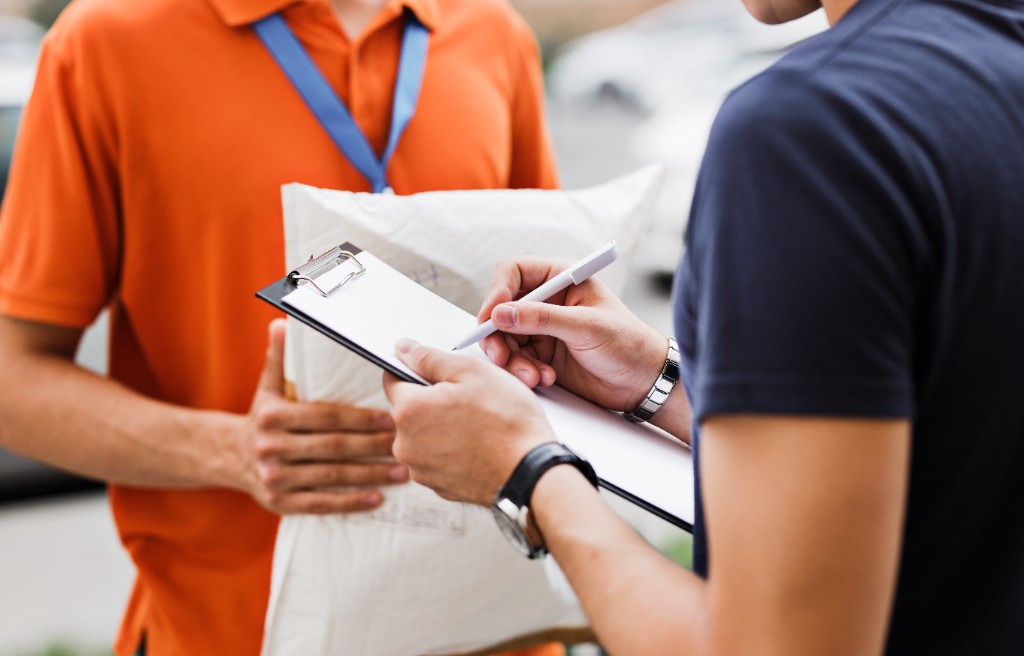 Customer signing a moving delivery confirmation form