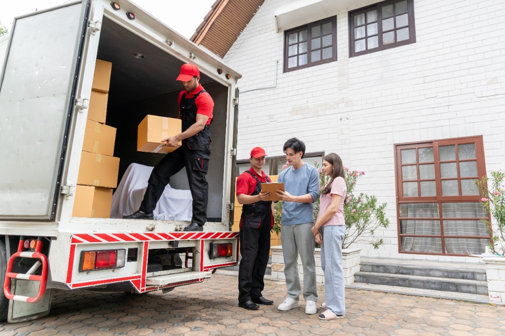 Family receiving moving boxes at their new home