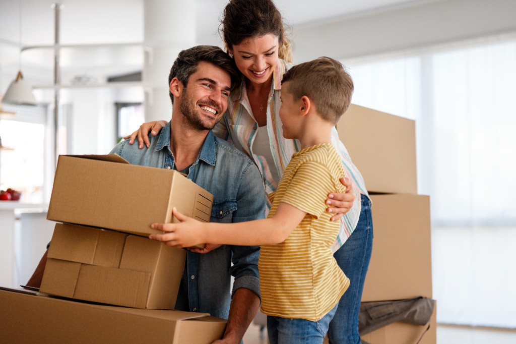 Happy family unpacking together after moving day