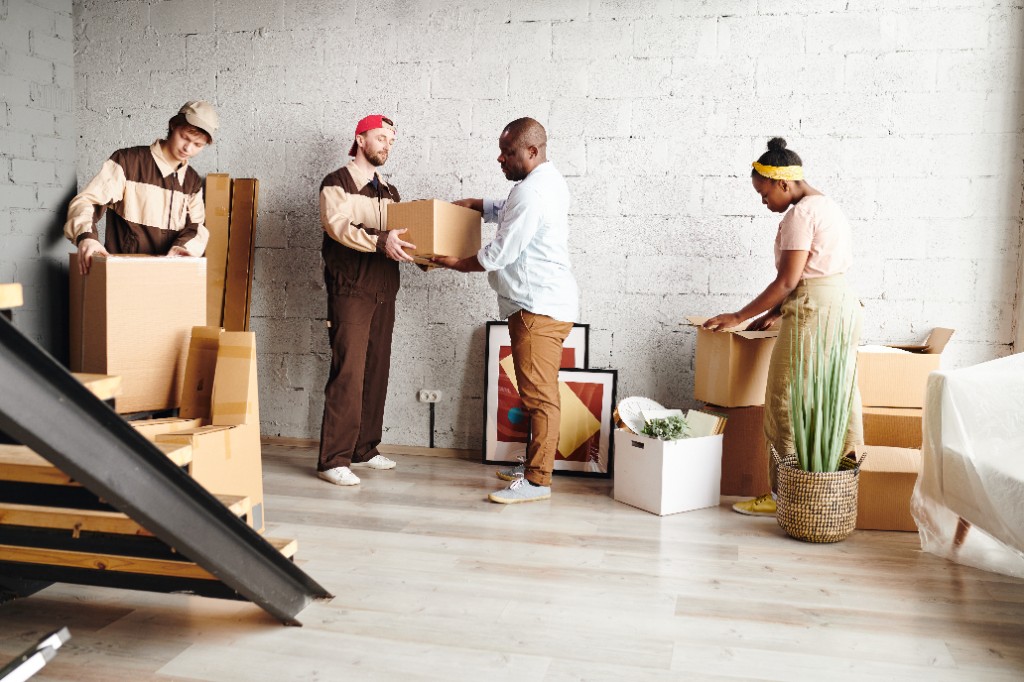 Movers unpacking boxes inside a new home