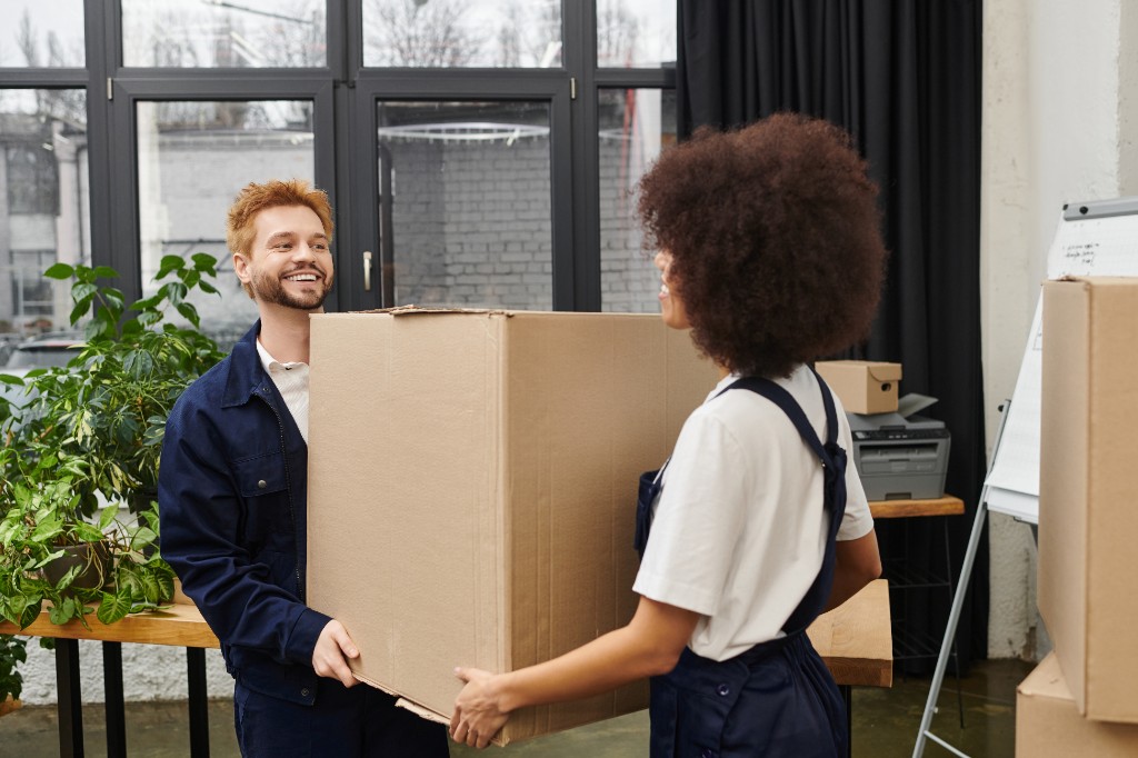 Office team relocating boxes and work supplies