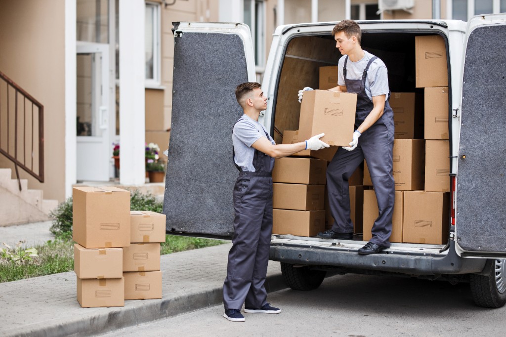 Residential moving team unloading boxes from a van